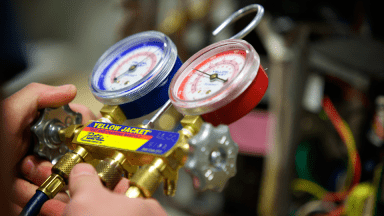 Close up of a person's hands as they hold a gauge.