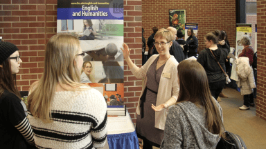 Professor talking to prospective students about English and humanities