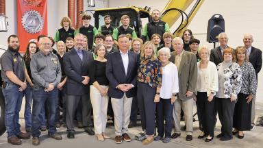 Members of the Roland Machinery Co. family pose with LLCC officials and diesel technologies students.
