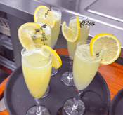 Garden Margarita Fizz mocktail in glasses garnished with lemon slices and fresh thyme