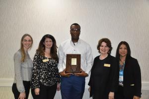 Max Kassa receiving an adult learner award.