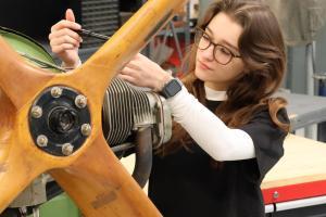 Female student working on an aircraft.