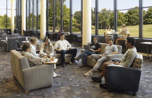 Students sitting and talking in the lower level of TLC