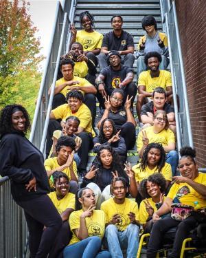 BSU Club members sitting on a stair case. 