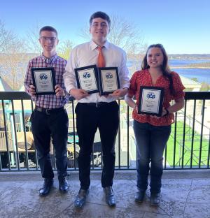 Three LLCC students pose with their award.