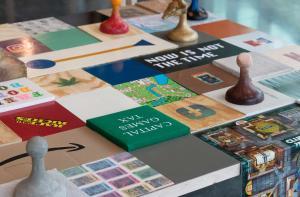 Artwork that includes a game board with different pieces and squares.