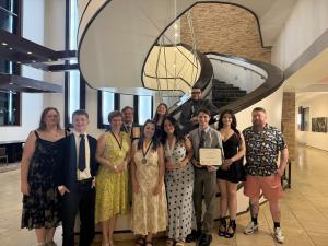 students stand on or near a staircase