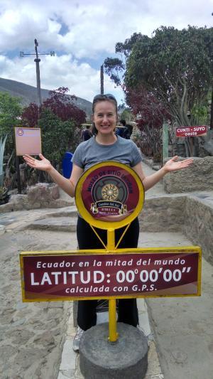 Natalie Coers standing at 0 latitude in Ecuador