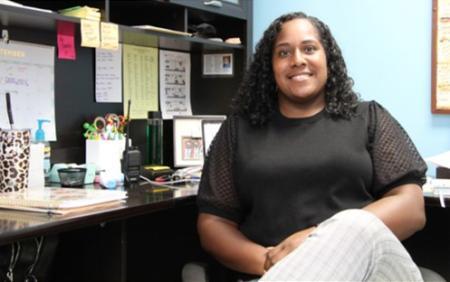 Serita Lott sitting at her desk