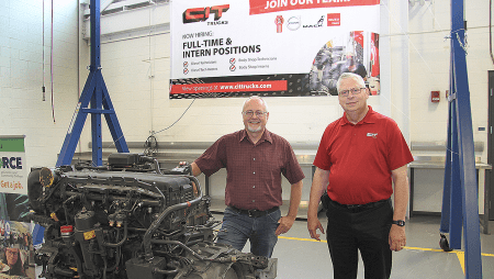Jeff Gardner and Chris Harrison with an MX-13 Paccar diesel engine.