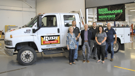 LLCC staff and Rush Truck Centers representatives pose for a photo in front of a GMC 550 truck donated by Rush.