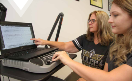 Diane Wilson working with student on monitoring brain waves on a computer