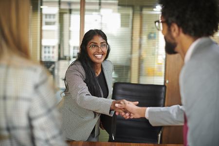 smiling female shaking hands with employer