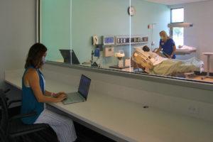 LLCC Nursing Instructor Bridgette Hudson observes nursing student Tracy Madonia as she practices skills in the labor/delivery lab of the new Nursing Education Center at LLCC. 