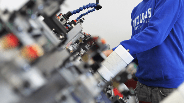 A student works on industrial technology parts.