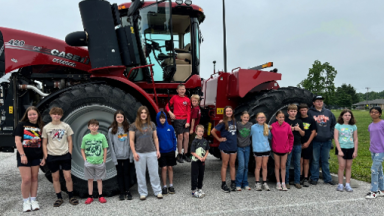 “Ag Explorers” campers in front of a tractor provided by Beard Implement